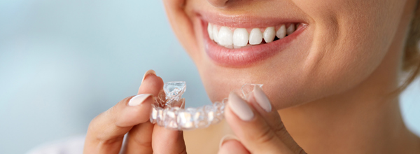 Smiling woman with clear aligners